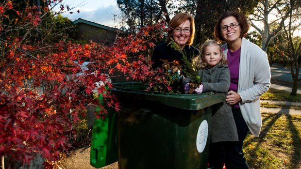 Municipal Minister Meegan Fitzharris (left) with Weston Creek residents Cath Collins and Cath's daughter Sammi. Ms Fitzharris says Labor has changed its position on providing garden waste bins.