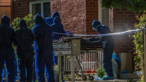 Police remove a dead body from a block of flats in Windeyer street Watson.