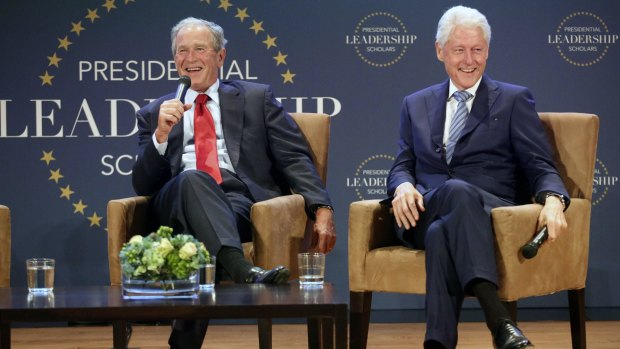 Former president George W. Bush (left) and former president Bill Clinton share a laugh during the Presidential Leadership Scholars Graduation at the George W. Bush Presidential Centre in University Park, Texas.