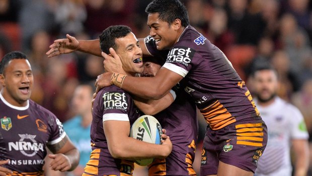 Too easy: Jordan Kahu of the Broncos celebrates with teammates after scoring a try.