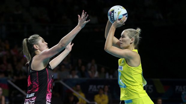 Australia's Courtney Bruce looks for a pass over New Zealand's Ta Paea Selby-Rickit.