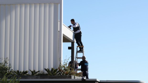 Police search the gutters of John Ibrahim's Dover Heights home.
