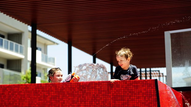 Oliver Wilson,10 and his brother Ryan, 6, cool off in the pool.