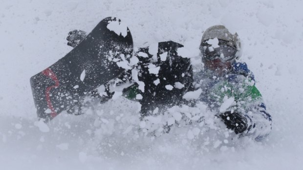 Can you tell the difference? A snowboarder enjoys a flurry on Friday.