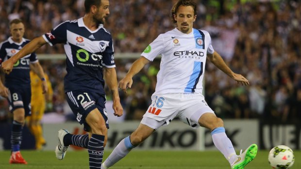 Clash: Joshua Kennedy takes on Carl Valeri of the Melbourne Victory.