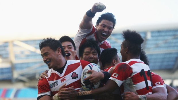 History: Japan celebrate their upset win over two-time champions South Africa.