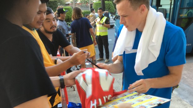 In demand: Man of the moment Brad Smith signs autographs for Thai fans.