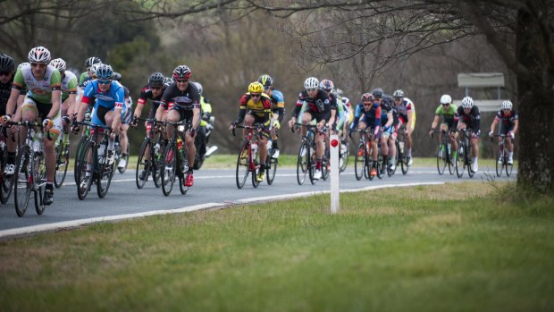 Competitors in the men's road race go across Lady Denman Drive on Saturday.
