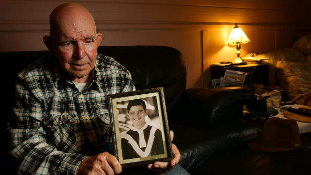 David Owen holds a photo of himself when he was at Neerkol Orphanage.