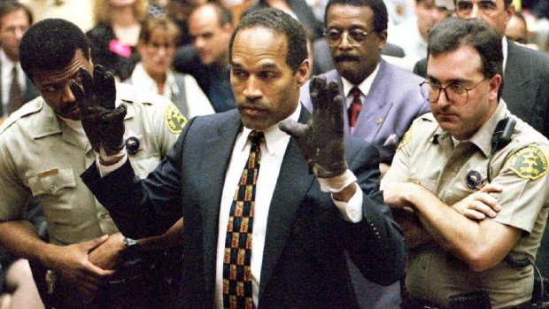 O.J. Simpson tries on the blood-stained gloves alleged to have been used in the killing of Nicole Simpson and Ron Goldman.