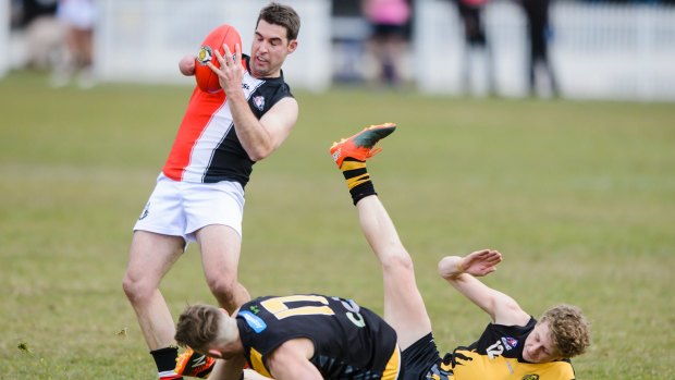 Ainslie Tricolours forward Matt Thompson is kicking bags with just one arm. 