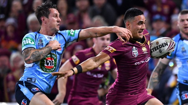 Left behind: Valentine Holmes of the Maroons gets past Mitchell Pearce.
