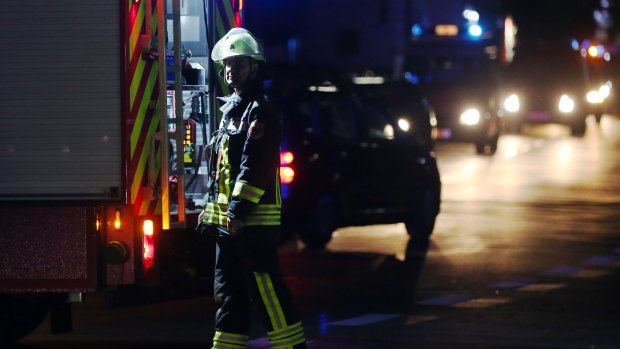 A firefighter stands at a road block in Wuerzburg after a man attacked people on a train.