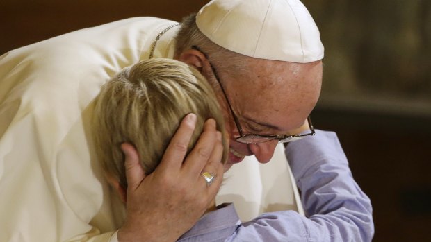 Pope Francis hugs a child during his visit to the Lutheran church, in Rome, on Sunday. 