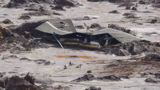 A farmhouse is buried in mud after the Samarco dam failure. 