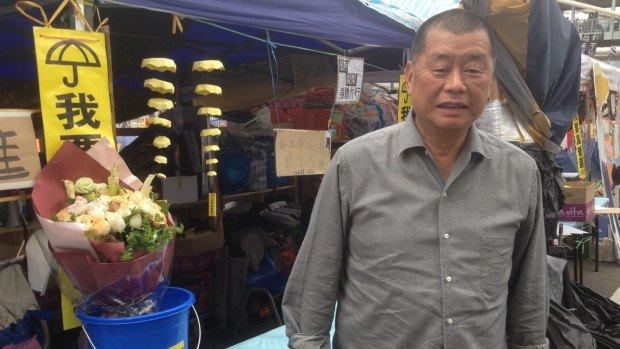 "I want genuine universal suffrage" reads the umbrella sign at Hong Kong Media magnate Jimmy Lai's tent. 