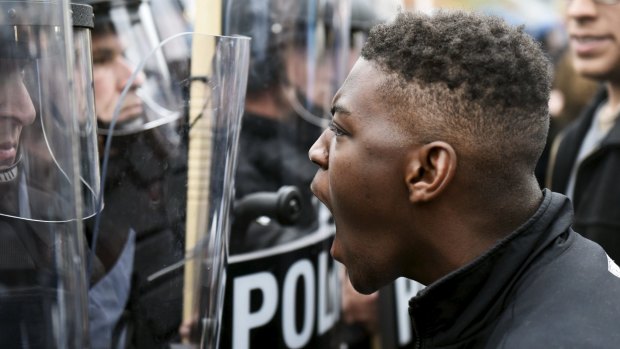 A demonstrator confronts police in Baltimore during a protest against the death in police custody of Freddie Gray.