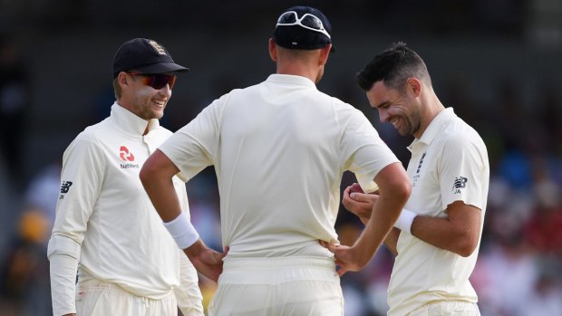 Root talks with Stuart Broad and Jimmy Anderson.