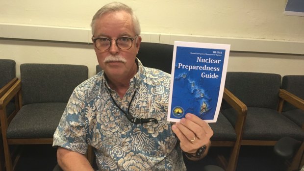 Toby Clairmont, the Hawaii Emergency Management Agency's executive officer, shows the new guide on Friday. 