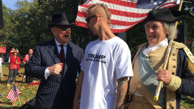 The dapper Roger Stone mixes with Trump supporters, one of them dressed as George Washington.