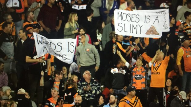 Not happy: Tigers fans showed their disapproval of departing stars Mitchell Moses and James Tedesco.