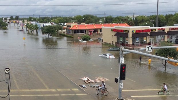 This image made from a video shows a view from US Route 59 of flooding on West Bellfort Avenue in Houston.