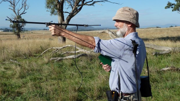 Professor George Wilson, seen here retrieving GPS collars used to track kangaroos in the ACT, says farmers need to have an interest in safeguarding kangaroos.