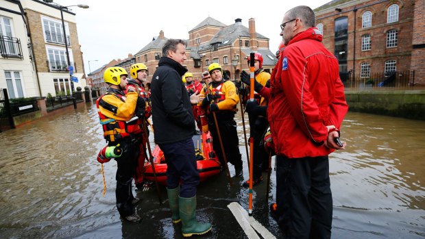 British Prime Minister David Cameron meets rescue teams working on flood relief in York city centre.