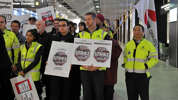 Workers at Melbourne Airport stop work amid an industrial campaign for better pay earlier this year.