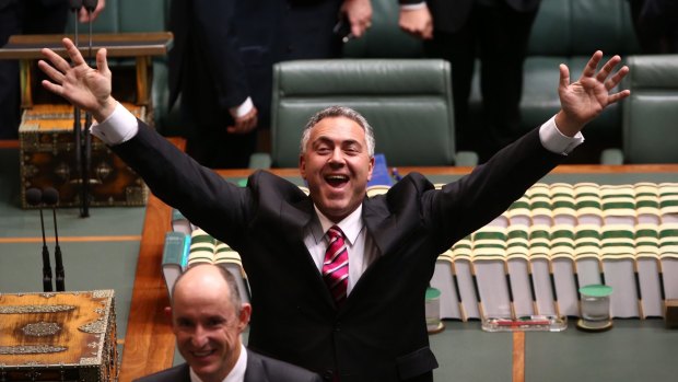 Treasurer Joe Hockey waves to the public gallery ahead of Opposition Leader Bill Shorten delivering the budget in reply address at Parliament House.