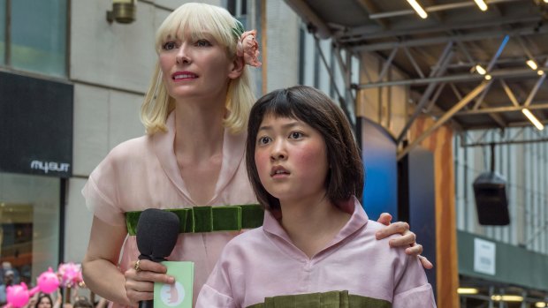 Tilda Swinton as Lucy Mirando (left) and Ahn Seo-Hyun as Mija in Okja.