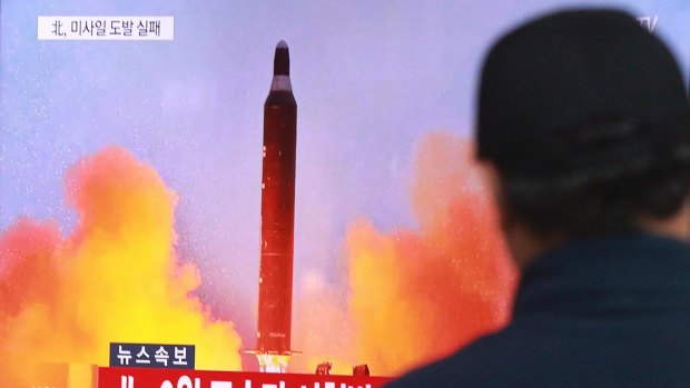 A man in Seoul watches a TV news program on North Korea's missile launches.