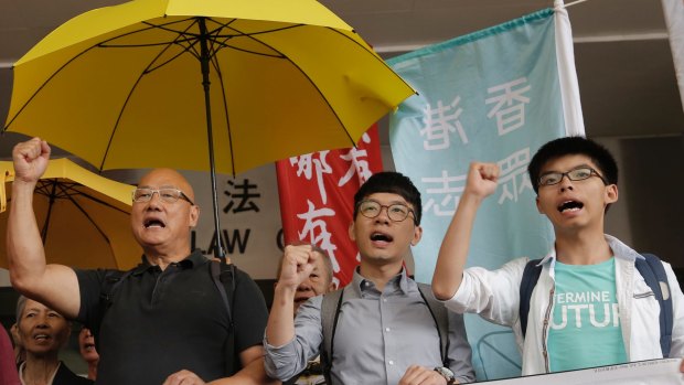 From left, lawmaker Albert Chan and pro-democracy leaders Nathan Law and Joshua Wong last year after Wong was acquitted of obstructing police at a 2014 protest.