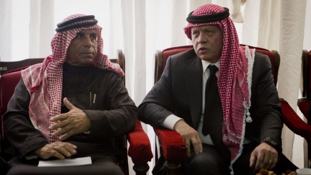 Condolences: Jordanian King Abdullah II (right) talks with Safi al-Kasasbeh, father of slain pilot Muath.