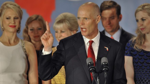 Republican Florida Governor Rick Scott celebrates his re-election in a deadlocked race against Democrat Charlie Crist during a US midterm elections night party with supporters in Bonita Springs, Florida.