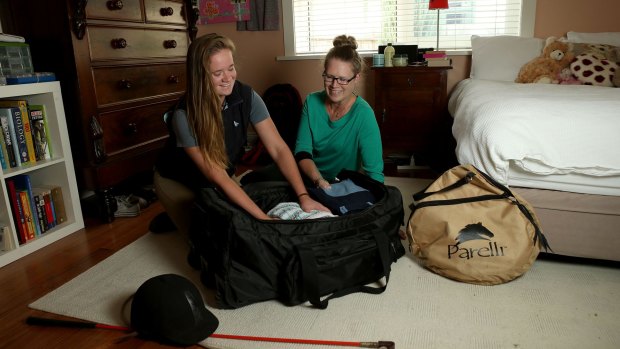 Milly Agar, left, with her mother Michelle, packs for another term at her Hamilton boarding school. She says boarding has been a positive experience.