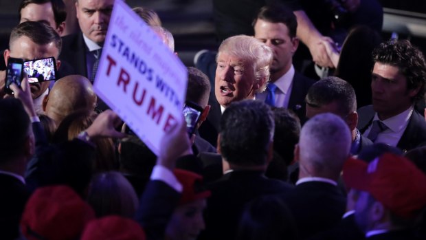 President-elect Donald Trump is swamped by supporters after giving his acceptance speech.