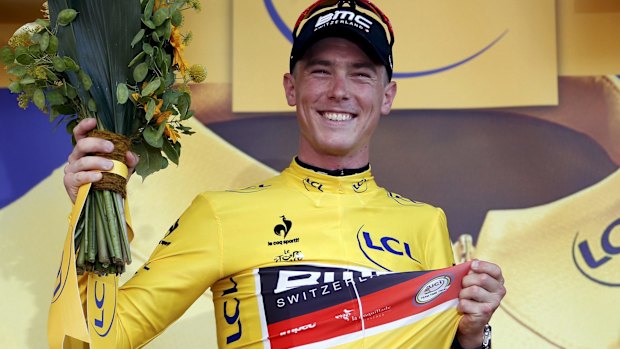 Australian Rohan Dennis proudly wears the race leader's yellow jersey on the podium after winning the first stage of the Tour de France. 