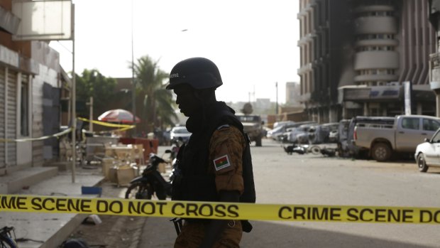 A soldier stand guards outside the Splendid Hotel in Ouagadougou, Burkina Faso.