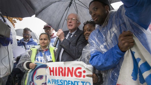 Senator Bernie Sanders joins low-wage workers, some who work as cooks and cleaners at the Capitol, during a rally to protest what they describe as poverty pay.