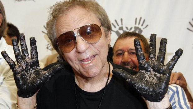Hal Blaine holds up his hands covered in cement after an induction ceremony for Hollywood's RockWalk.