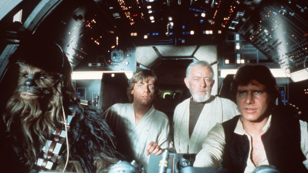Chewbacca (Peter Mayhew), left, and Han Solo (Harrison Ford), right, fly Luke Skywalker (Mark Hamill), second left, and Ben "Obi-Wan" Kenobi (Alec Guinness) in the Millenium Falcon in Star Wars Episode IV: A New Hope.
