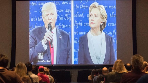 Republican presidential nominee Donald Trump, left, and Democratic presidential nominee Hillary Clinton are displayed on a big screen at the University of Cincinnati.