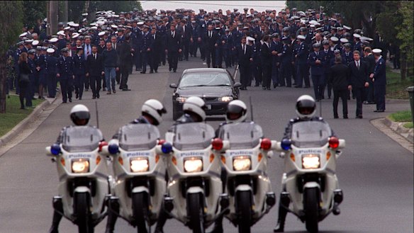 Police officers gather on Mountain View Road as they farewell murdered colleague Gary Silk.