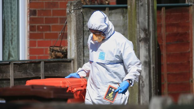 Police forensic investigators search the property of Salmon Abedi in connection with the Manchester attack.