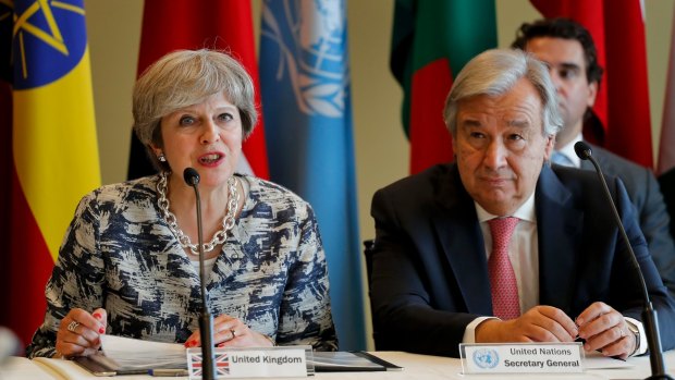British Prime Minister Theresa May, left, speaks at a UN side panel next to UN Secretary General Antonio Guterres in New York on Tuesday.