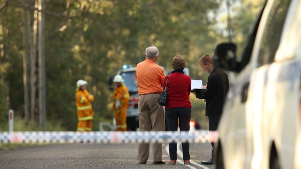 Police interview witnesses at a roadblock near the scene of an ultralight plane crash at Lovedale.