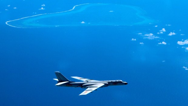 A Chinese bomber patrols South China Sea reefs and islands.  
