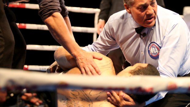 Referee Brad Vocale attends to Bowie Tupou after being knocked out.