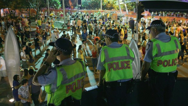 Police officers watch over the schoolies week celebrations in Surfers Paradise. The study found that revellers who did get into trouble would be most likely to turn to their friends for help.